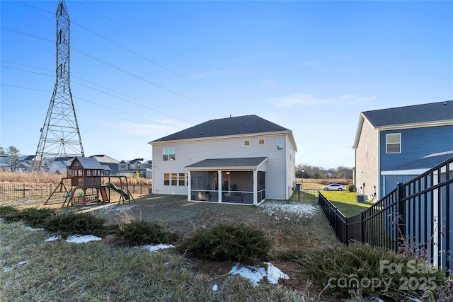 back of house with a playground and a sunroom