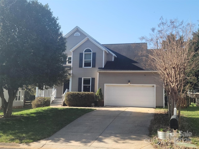 traditional-style house with concrete driveway, a front lawn, and an attached garage