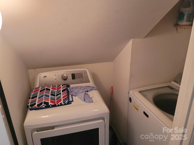 clothes washing area featuring laundry area and washing machine and clothes dryer