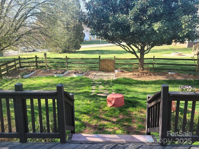 view of yard featuring fence and a garden