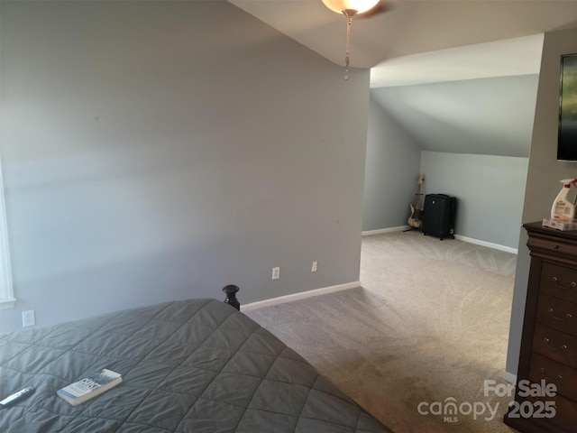 bedroom with vaulted ceiling, carpet flooring, a ceiling fan, and baseboards