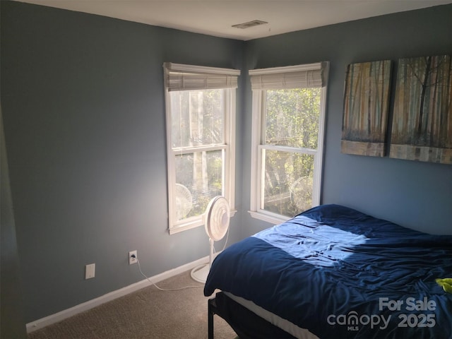 carpeted bedroom with visible vents and baseboards