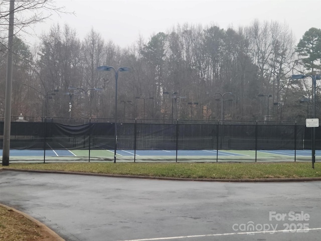 view of tennis court with fence