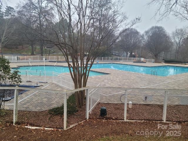 pool featuring a patio area and fence