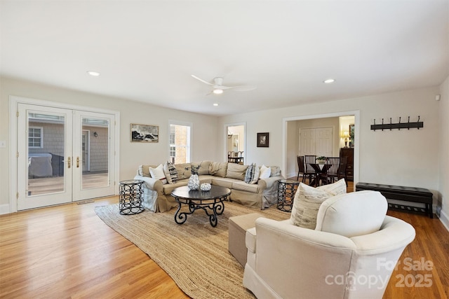 living area featuring recessed lighting, visible vents, wood finished floors, and french doors