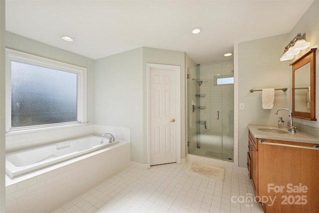 bathroom featuring tile patterned flooring, recessed lighting, vanity, a bath, and a stall shower