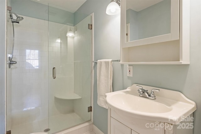 bathroom with a stall shower and vanity