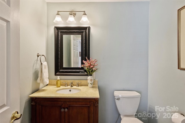 bathroom with toilet and vanity