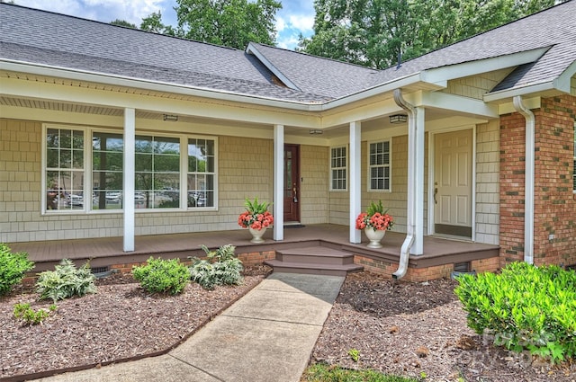 7135 Folger Dr, Charlotte, NC 28270 - view of exterior entry featuring a porch, a shingled roof, and crawl space