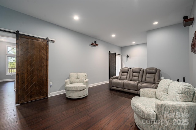 living room with dark hardwood / wood-style floors and a barn door