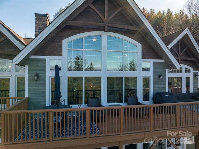 rear view of house featuring a deck