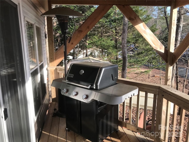 wooden deck featuring a grill