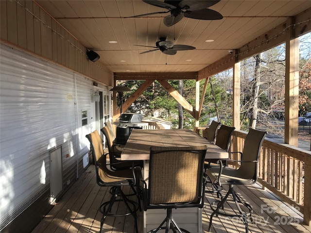 wooden deck featuring ceiling fan