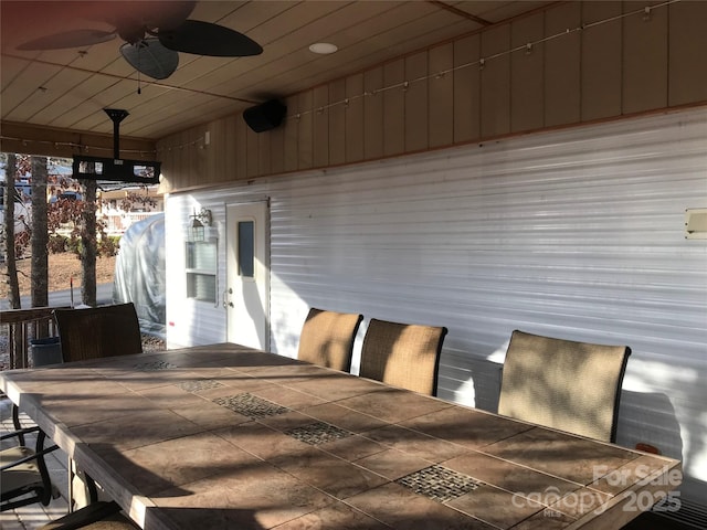 exterior space with ceiling fan and an outdoor bar