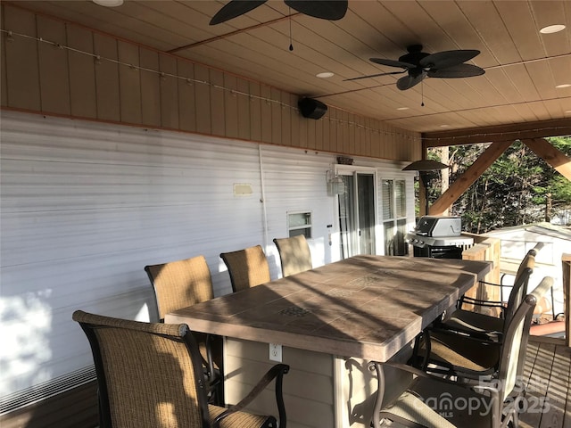 view of patio / terrace featuring ceiling fan, exterior bar, and grilling area