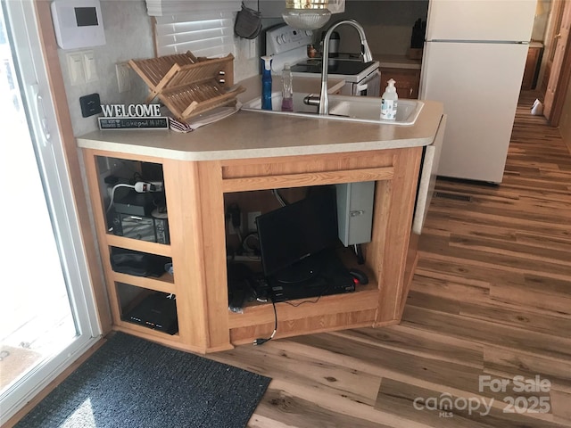 interior details with hardwood / wood-style floors and white appliances