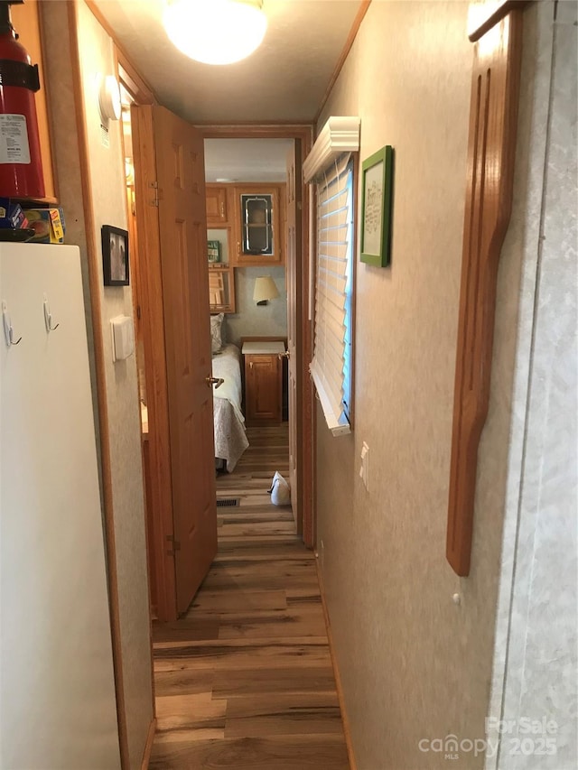 corridor with wood-type flooring