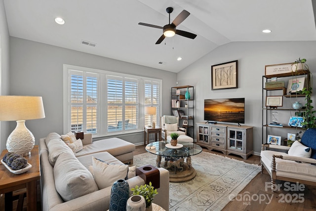 living room with lofted ceiling, ceiling fan, and hardwood / wood-style floors