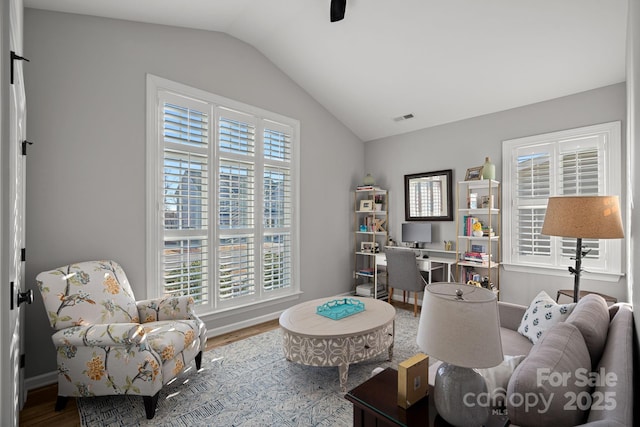 living room with vaulted ceiling and hardwood / wood-style floors