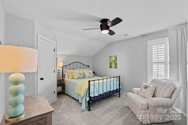 bedroom with ceiling fan, vaulted ceiling, and carpet