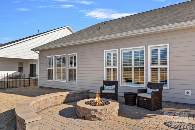 rear view of house featuring a patio area and a fire pit