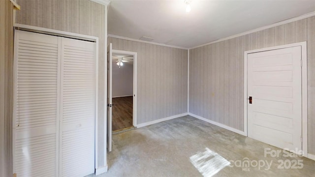 unfurnished bedroom featuring baseboards, ornamental molding, and a closet