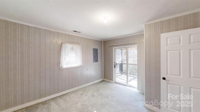 empty room with light carpet, ornamental molding, visible vents, and electric panel