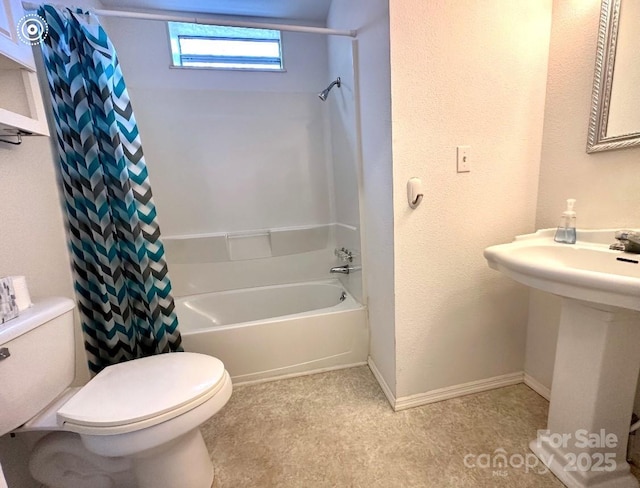 bathroom with shower / tub combo, baseboards, a sink, and toilet