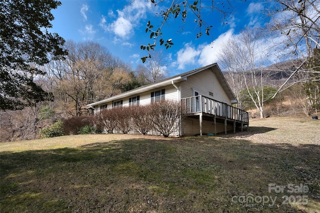 view of property exterior featuring a deck and a yard