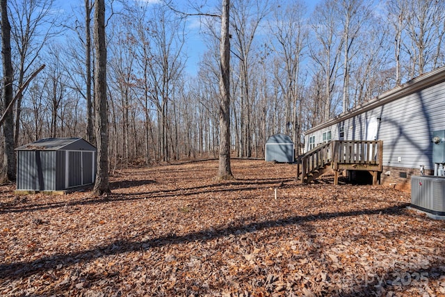 view of yard with a storage shed and central air condition unit