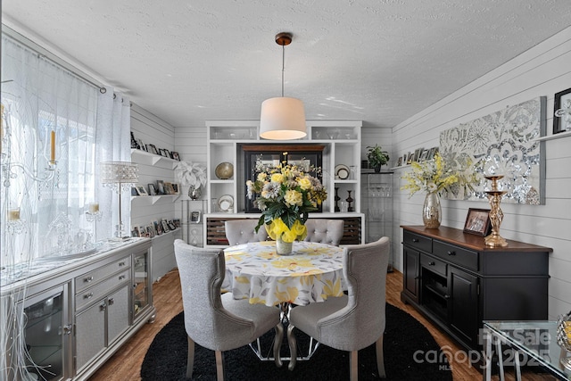 dining area featuring dark hardwood / wood-style floors and a textured ceiling