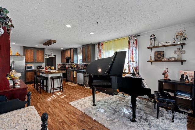 misc room featuring hardwood / wood-style floors and a textured ceiling