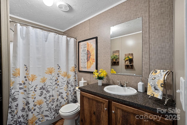 bathroom with crown molding, vanity, a textured ceiling, and toilet