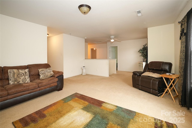 carpeted living room with ceiling fan