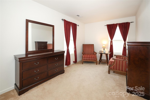 living area with a healthy amount of sunlight and light colored carpet