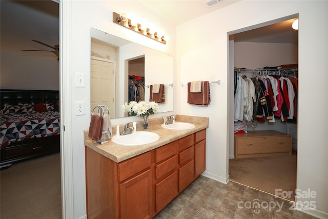 bathroom featuring ceiling fan and vanity