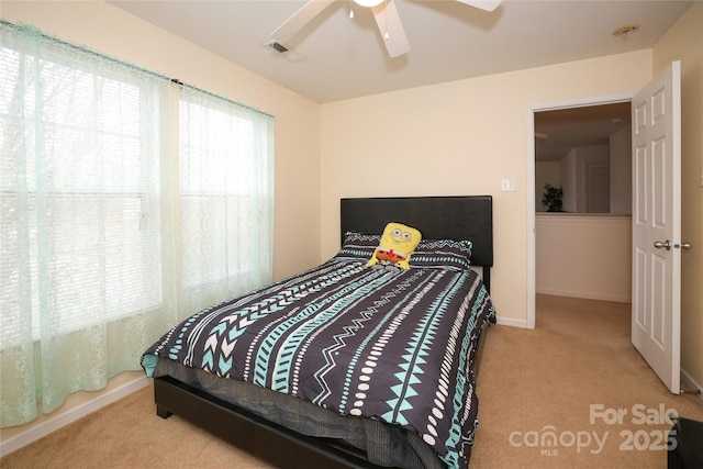 bedroom with ceiling fan and light colored carpet