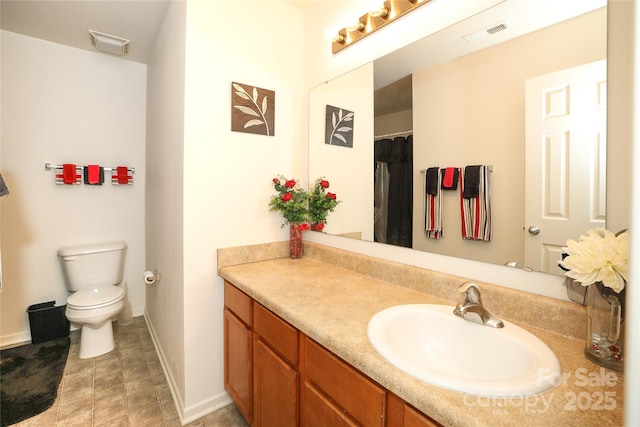 bathroom with toilet and vanity