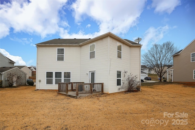 back of house with a wooden deck and a lawn