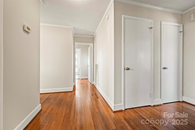 corridor featuring wood-type flooring and crown molding