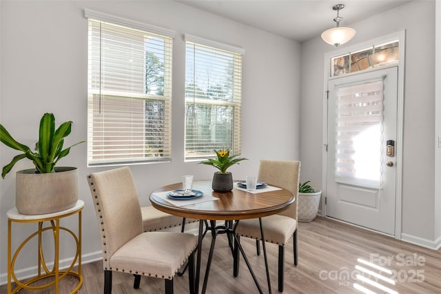 dining space with light wood-type flooring