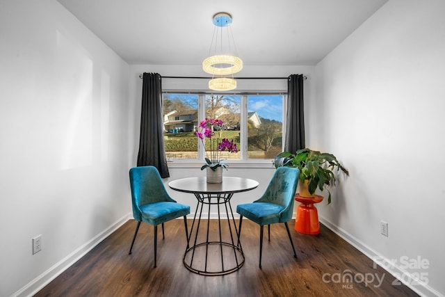 dining space featuring a notable chandelier and dark hardwood / wood-style flooring