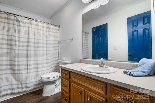 bathroom featuring hardwood / wood-style flooring, toilet, vanity, and ornamental molding