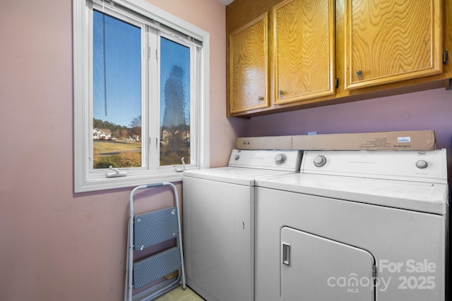 clothes washing area with independent washer and dryer and cabinets