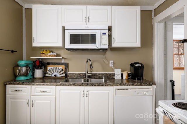 kitchen featuring white cabinetry, sink, and white appliances