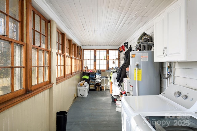 laundry room featuring water heater, cabinets, wood ceiling, and washing machine and dryer