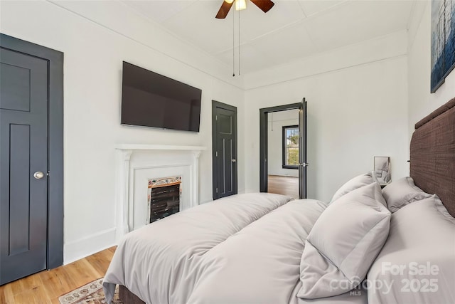 bedroom featuring hardwood / wood-style floors and ceiling fan