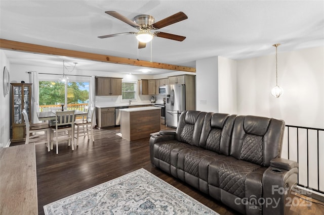 living room featuring ceiling fan, a wealth of natural light, beam ceiling, and dark hardwood / wood-style floors