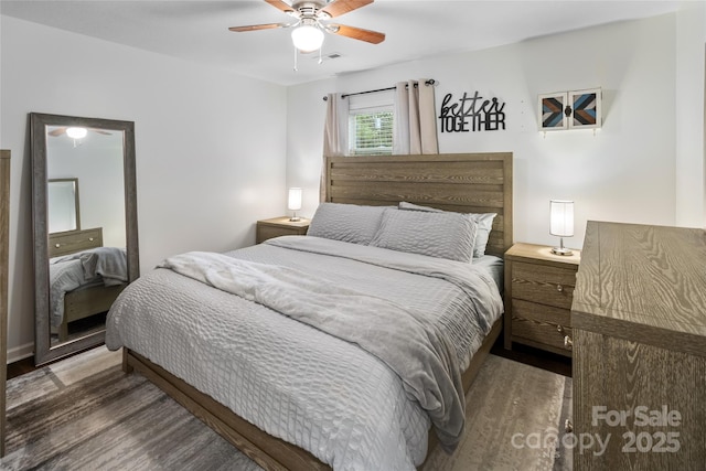 bedroom featuring ceiling fan and dark hardwood / wood-style floors