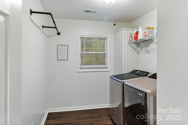 clothes washing area featuring dark hardwood / wood-style floors and separate washer and dryer